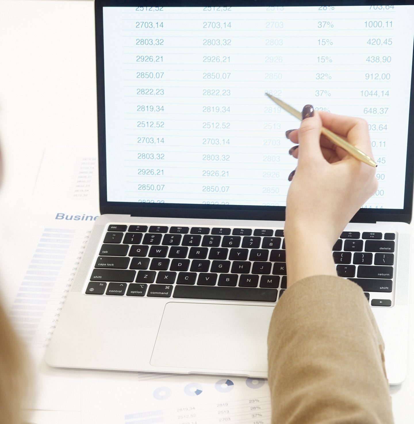 Business professional analyzing financial data on a laptop for strategic decision making.