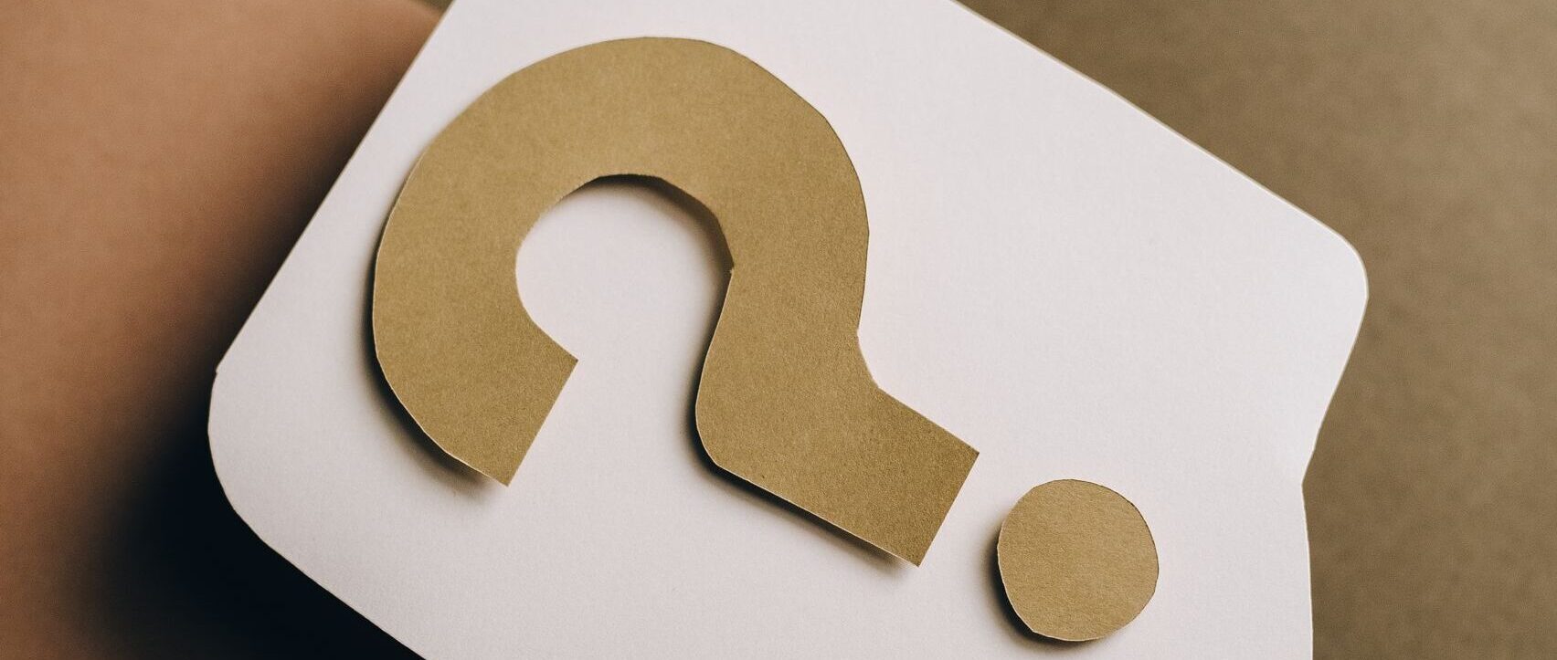 Artistic paper craft of a question mark on neutral background. Ideal for concept themes.